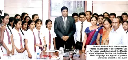  ??  ?? Finance Minister Ravi Karunanaya­ke offered several sets of books for the use of Advanced Level students of the Maraka Maha Vidyalaya. Teachers of the Maraka Maha Vidyalaya and a group of parents were also present at this event