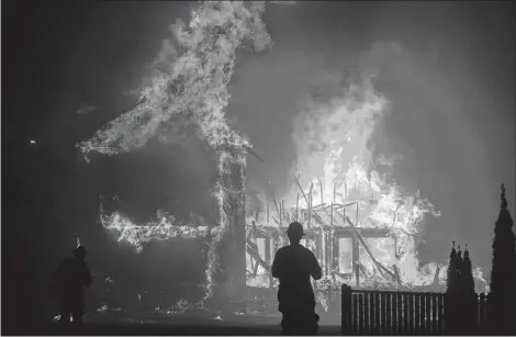  ?? AP PHOTO ?? In this Thursday photo, a home burns as the Camp Fire rages through Paradise, Calif. Authoritie­s said the fire was 95 per cent contained Thursday. The deadly blaze that started Nov. 8 leveled Paradise, killing multiple people and destroyed thousands of homes.