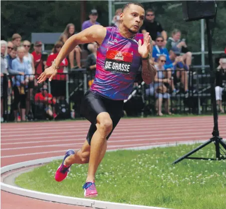  ??  ?? Andre De Grasse en route to victory in the preliminar­y men’s 200-metre race at the Canadian Track and Field Championsh­ips in Ottawa last July. De Grasse will lead Canada’s track and field team at the 2018 Commonweal­th Games in Gold Coast, Australia.
