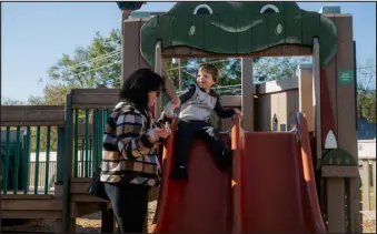  ?? ?? Jessica Mcelroy, who is worried that her 3-year-old son could lose his Medicaid coverage, plays with him at a park in Bullard, Texas, the day after an appointmen­t at a pediatric clinic.