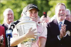  ?? Richard Heathcote / Getty Images ?? Justin Thomas celebrates with the Wanamaker Trophy after putting in to win on the third playoff hole of the PGA Championsh­ip on Sunday in Tulsa, Okla.