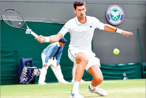  ?? GLYN KIRK/AFP ?? Serbia’s world No1 and defending champion Novak Djokovic returns against France’s Ugo Humbert during their men’s singles fourth round match at the 2019 Wimbledon Championsh­ips at The All England Lawn Tennis Club in Wimbledon, southwest London, on Monday.