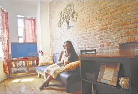  ?? BEBETO MATTHEWS/ASSOCIATED PRESS ?? Ashley Warmington, CEO of Cozy Oasis, a short-term rental concierge company, sits in the living room of a property that she manages listings for in New York. Warmington is partnering her company’s services with the anti-racism lodging website Noirbnb.