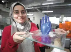  ?? — Reuters ?? An employee shows a 3D-printed prosthetic hand, created at the Fablab in city of Irbid, Jordan.