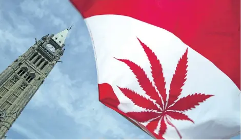  ?? DONALD WEBER/GETTY IMAGES ?? A Canadian flag with a marijuana leaf flies during a rally in support of legalizing marijuana on June 5, 2004, alongside Parliament Hill in Ottawa soon after the Supreme Court of Canada then upheld a decision to keep marijuana as a banned substance.