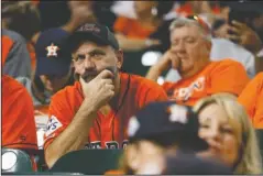  ?? The Associated Press ?? THE LATE SHOW: Fans watch Wednesday during the eighth inning of Game 2 of the World Series between the Houston Astros and the Washington Nationals in Houston.