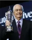  ?? PAUL SANCYA — THE ASSOCIATED PRESS ?? Roger Penske holds his “Baby Borg” trophy in January in Detroit.