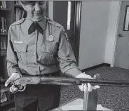  ?? National Park Service via AP ?? Rifle: In this April photo provided by the National Park Service, park archaeolog­ist Eva Jensen holds the 1882 Winchester rifle she found leaning against a trip in Great Basin National Park in 2014 near Baker, Nev. A new exhibit featuring the "Forgotten Winchester" has opened at the park's visitor center near the Nevada-Utah line.