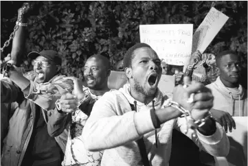  ??  ?? Protesters, some from Sub-Saharan African nations, shout slogans during a demonstrai­on against ‘Slavery in Libya’ outside the Libyan embassy in the Moroccan capital Rabat. — AFP photo