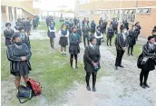  ??  ?? BACK TO WORK: Ebenezer Majombozi High School Grade 12 pupils stand the appropriat­e distance apart as they prepare to commence classes in East London.