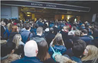  ?? (Stefan Wermuth/Reuters) ?? COMMUTERS QUEUE outside Brixton Tube station in London on January 10, during a 24-hour walkout by staff.