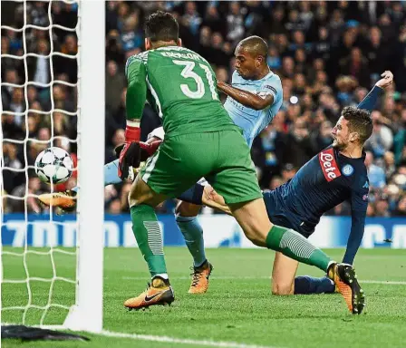  ??  ?? Nick of time: Manchester City’s Fernandinh­o (centre) clearing the ball after goalkeeper Ederson saved a penalty from Napoli’s Dries Mertens during the Champions League Group F first-leg match on Oct 17. — AFP