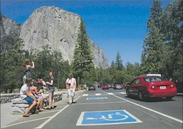  ?? Mark Crosse Fresno Bee ?? TOURISTS at Yosemite’s El Capitan. Leaders on a federal advisory panel say changes such as expanding WiFi and offering Amazon deliveries at campsites could make national parks more attractive to younger visitors.