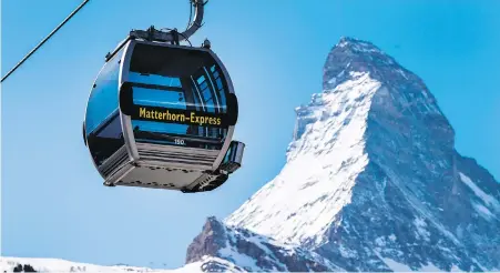  ??  ?? A Matterhorn-Express gondola lift in front of the Matterhorn in the Zermatt ski resort, in Zermatt, Switzerlan­d.