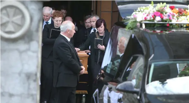  ??  ?? UNTIMELY TRAGEDY: Donna Fox’s partner Anne Marie Ryan (left) and her sister, Leanne, after her funeral mass at St Peter and Paul’s Church in Balbriggan