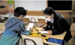  ?? —REUTERS ?? FREE WI-FI Diego Guerrero, 7, and Sofia Diaz, 7, connect to the internet thanks to Starlink’s satellite antenna at the John F Kennedy School in Cochamo, Chile.