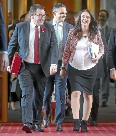  ?? KEVIN STENT/STUFF ?? Finance Minister Grant Robertson and Prime Minister Jacinda Ardern on their way to presenting the Labour-led coalition Government’s first Budget in Parliament yesterday. Following is Greens co-leader James Shaw.