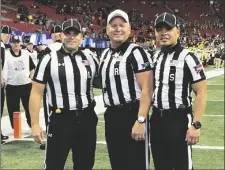  ?? PHOTO VIA AP ?? In this Dec. 29, 2018 photo provided by Lo van Pham (from left) line judge Derek Anderson, referee Mike Defee and side judge Lo van Pham pose for a photo before the Peach Bowl NCAA college football game in Atlanta.