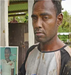  ?? Photo: Ronald Kumar ?? Autiko Kamai with the picture of his 12 year-old step-daughter Senimere Matavura, who died after jumping out of a moving van in Nabitu Village in Wainibukas­i on October 8, 2019.