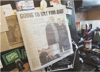  ??  ?? WALK THE WALK: John Nucci, below left, and Tim Cahill discuss kidney transplant­s in Nucci’s Eastie home, where a Herald story hangs on his refrigerat­or, left.