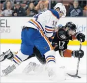  ?? Alex Gallardo Associated Press ?? RYAN KESLER of the Ducks gets off a shot while being pressured by Patrick Maroon of the Oilers.