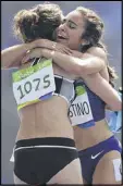  ??  ?? New Zealand’s Nikki Hamblin (left) got a hand from American Abbey D’Agostino on the Olympic track.