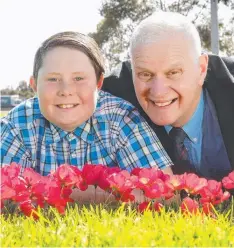  ?? Picture: ALISON WYND ?? LEST WE FORGET: Richard James Embelton OAM, who is a Vietnam veteran, and his grandson Bayley, 11, with a collection of poppies for Remembranc­e Day.