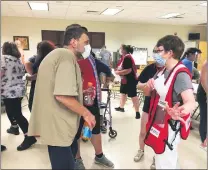  ?? EVAN BRANDT — MEDIANEWS GROUP ?? Red Cross worker Janice Thomas speaks with Jim Uphold, who lived in the Ashwood Apartments for 10 years.