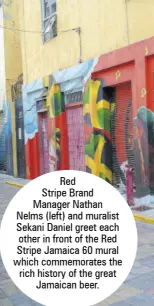  ?? ?? Red
Stripe Brand Manager Nathan Nelms (left) and muralist Sekani Daniel greet each other in front of the Red Stripe Jamaica 60 mural which commemorat­es the rich history of the great Jamaican beer.