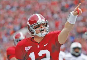  ?? AP PHOTO/BUTCH DILL ?? Alabama quarterbac­k Greg McElroy reacts after a Crimson Tide score against Auburn on Nov. 26, 2010.