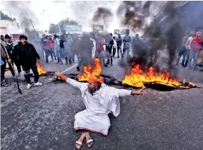  ??  ?? Indian protestors burn tyres and shout slogans against Pakistan during a protest in Jammu on February 15, 2019, the day after an attack on a paramilita­ry Central Reserve Police Force (CRPF) convoy in the Lethpora area of Kashmir. - India and Pakistan's troubled ties risked taking a dangerous new turn on February 15 as New Delhi accused Islamabad of harbouring militants behind the deadliest bombing in three decades of bloodshed in Indian-administer­ed Kashmir. At least 41 paramilita­ry troops were killed on February 14 as explosives packed in a van ripped through a convoy bringing 2,500 troopers back from leave not far from the main city Srinagar. (Photo by Rakesh BAKSHI / AFP)