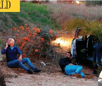  ?? JACK GUEZ / AFP / GETTY IMAGES ?? Israelis take cover as rockets are fired from the Gaza Strip into the southern Israeli town of Sderot on Monday, after an attempted incursion into Gaza by Israeli commandos on Sunday night went wrong.