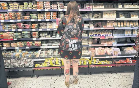  ?? REUTERS ?? A shopper looks at food on display at a store in London, Britain.