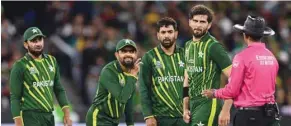  ?? ?? Pakistan’s Babar Azam (centre) listens to Sri Lanka’s umpire Kumar Dharmasena (right) during the ICC Twenty20 World Cup 2022 final against England at the Melbourne Cricket Ground yesterday. (AFP)