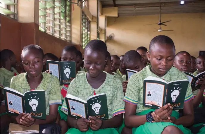  ??  ?? A cross section of junior school students reading from the book, 'Insight: Nuggets of Excellence for Teenagers' by Maryam Popoola