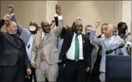  ?? JOHN MINCHILLO ?? Philonise Floyd, brother of George Floyd, center left, attorney Ben Crump, center right, and the Rev. Al Sharpton, right, raise their hands during a news conference after the murder conviction against former Minneapoli­s police Officer Derek Chauvin in the killing of George Floyd, Tuesday, April 20, 2021, in Minneapoli­s.