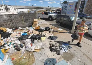  ?? Mel Melcon Los Angeles Times ?? IN OCTOBER, L.A. County officials declared a typhus outbreak in downtown L.A. around skid row. The announceme­nt prompted calls to clean up the streets and find housing for the city’s homeless population.