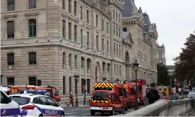  ??  ?? Emergency services at the scene in Paris. Photograph: Yoan Valat/EPA