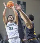  ?? TORK MASON/USA TODAY NETWORK-WISCONSIN ?? UWGB’s Noah Reynolds (21) shoots against UW-Milwaukee during the quarterfinals of the Horizon League tournament Thursday at the Kress Center in Green Bay. Reynolds finished with a team-high 27 points.