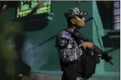  ?? SALVADOR MELENDEZ — THE ASSOCIATED PRESS ?? National Civil Police patrol the Vista al Lago neighborho­od, formerly under the control of the Mara Salvatruch­a gang, in Ilopango, El Salvador, on March 2.