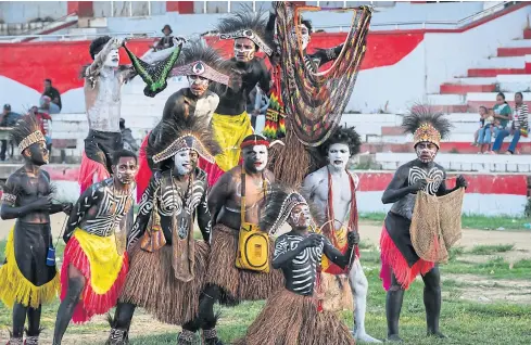  ??  ?? Papuan youths parade on a Sorong sports field during the first Festival Noken in Irian Jaya, Indonesia.
