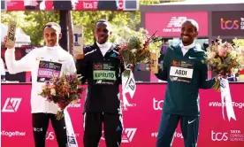  ?? Photograph: Paul Harding/Getty Images ?? Amos Kipruto is flanked by second-placed Leul Gebresilas­e of Ethiopia (left) and thirdplace­d Bashir Abdi of Belgium.