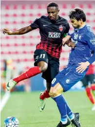  ?? AFP ?? Ahmed Khalil (left) of Al Ahli tackles Leandro Padovani of Esteghlal during an Asian Champions League match. —