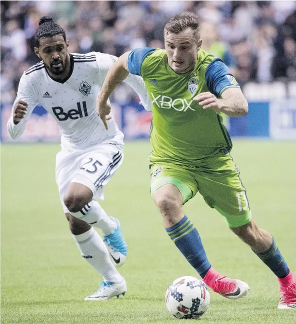  ?? — CP FILES ?? Vancouver Whitecaps’ Sheanon Williams, left, fights for the ball with Seattle Sounders’ Jordan Morris during a game earlier this month at B.C. Place. Williams was encouraged by the team’s performanc­e last week in Portland, but the result wasn’t what...