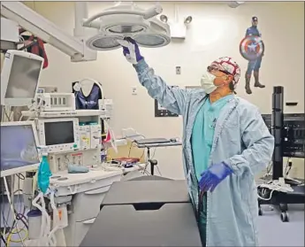  ?? JESSE GONZALEZ, K. C. Alfred San Diego Union- Tribune ?? an environmen­tal services attendant at Rady Children’s Hospital in San Diego, was among the front- line workers there to get a Pfizer- BioNTech COVID- 19 vaccine shot this week.