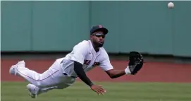  ?? STuArT cAhill / hErAld sTAff filE ?? I GOT THIS: Jackie Bradley Jr., one of the Red Sox’ best defensive center fielders of all time, stretches out for a catch last summer.