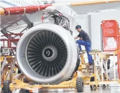  ??  ?? An employee installs an engine for an A320 plane under constructi­on at the final assembly line of the Airbus factory in Tianjin municipali­ty. UK private equity firm Better Capital’s sale of airplane parts firm NAL to a Chinese buyer has fallen through...