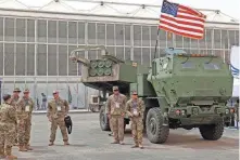  ?? FAYEZ NURELDINE/AFP VIA GETTY IMAGES ?? American military personnel stand by a M142 High Mobility Artillery Rocket System (HIMARS) at Saudi Arabia’s World Defense Show in March.