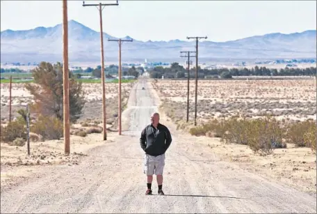  ?? Photograph­s by Irfan Khan
Los Angeles Times ?? DARON BANKS stands on the empty road leading to his home in Hinkley. “At some point ... we’re going to get some closure,” he said.