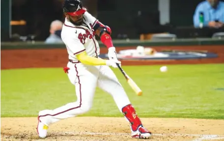  ?? AP PHOTO/ ERIC GAY ?? The Atlanta Braves’ Marcell Ozuna hits a home run against the Los Angeles Dodgers during the fourth inning of Game 4 of the NL Championsh­ip Series on Thursday in Arlington, Texas. The game was not complete at press time. Please visit timesfreep­ress.com for coverage.